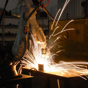 Image showing an industrial robot while welding.