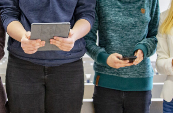 two people holding mobile devices